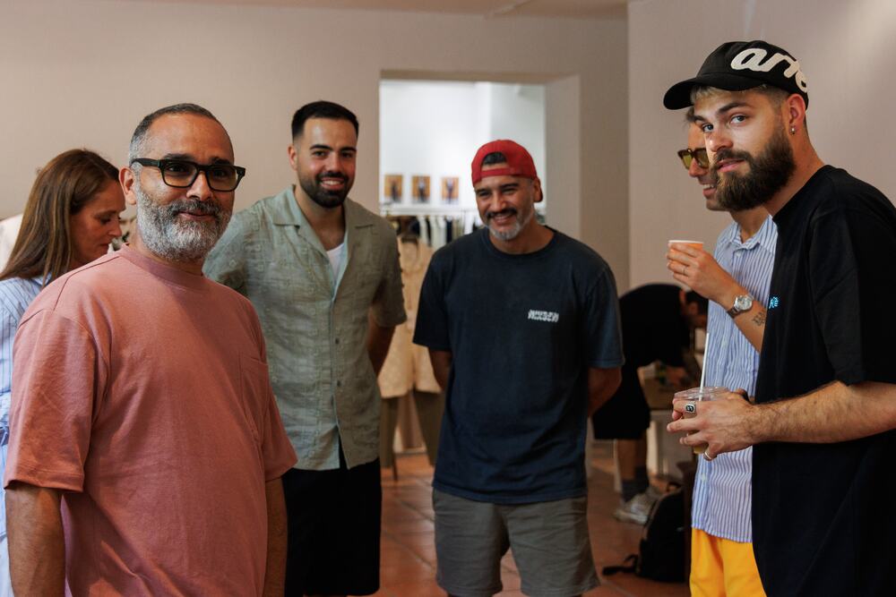 Brands and buyers laughing together in the showroom.