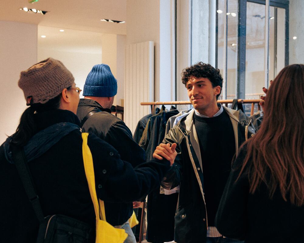 Buyers and brands talking in a busy showroom.