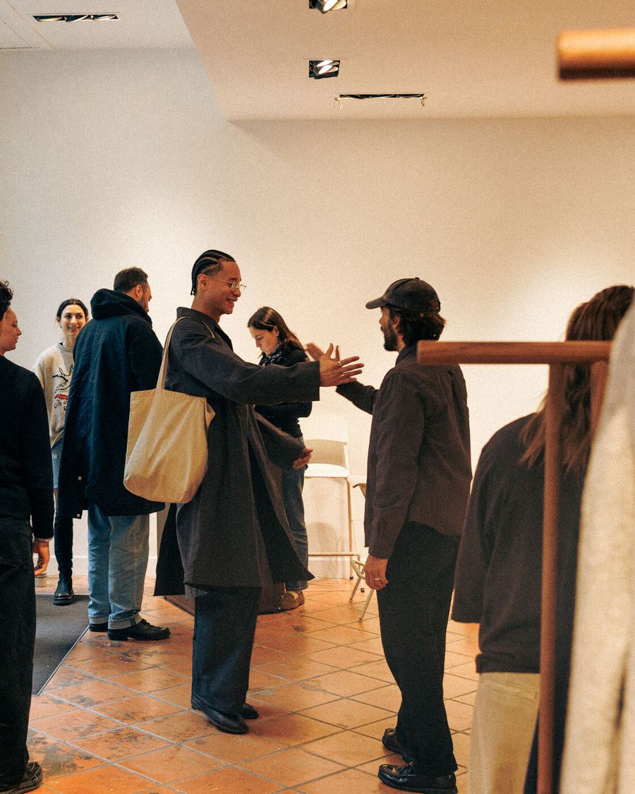 Buyers standing among the rails on the terracotta floor.