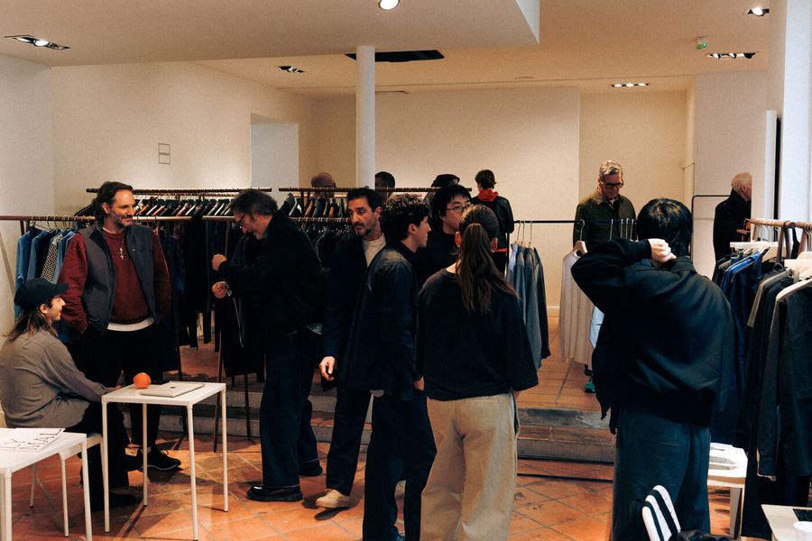 Buyers and brands moving between the rails in a full room.
